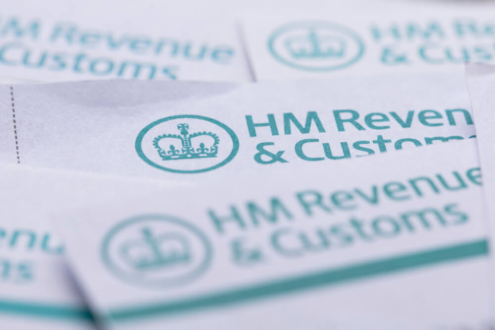 Umbrella employees reviewing tax return documents and payslip information, highlighting UK Self Assessment requirements, filing preparation, and the importance of starting tax planning in June.